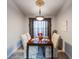 Bright dining room with wood table and four chairs at 2758 Turnbull Cove Dr, New Smyrna Beach, FL 32168