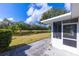 Exterior view of the home showcasing a screened porch and beautiful pond views at 2758 Turnbull Cove Dr, New Smyrna Beach, FL 32168