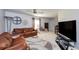 Spacious Gathering room with two leather couches, a TV, and ' play area at 2758 Turnbull Cove Dr, New Smyrna Beach, FL 32168