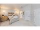 Spacious main bedroom with tufted headboard and ensuite bathroom access at 2758 Turnbull Cove Dr, New Smyrna Beach, FL 32168