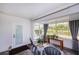 Bright screened porch with water views, comfortable seating, and a wood table at 2758 Turnbull Cove Dr, New Smyrna Beach, FL 32168