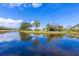 Peaceful lakefront property with lush landscaping and serene reflections at 2758 Turnbull Cove Dr, New Smyrna Beach, FL 32168