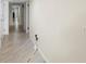 Long hallway with light walls and wood-look tile floors at 3003 S Atlantic Ave # 6A1, Daytona Beach, FL 32118