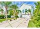 Light teal house with white garage and lush landscaping at 3110 John Anderson Dr, Ormond Beach, FL 32176