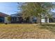 Backyard view of home with covered lanai at 3169 Connemara Dr, Ormond Beach, FL 32174