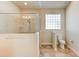 Walk-in shower and toilet in a bright bathroom at 3169 Connemara Dr, Ormond Beach, FL 32174