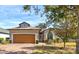Charming single-story home featuring a brick driveway, manicured lawn, and a symmetrical façade at 3169 Connemara Dr, Ormond Beach, FL 32174