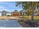 House exterior showcasing a wooden garage door and brick driveway at 3169 Connemara Dr, Ormond Beach, FL 32174