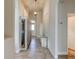 Spacious hallway featuring a glass-front cabinet and a light fixture at 3169 Connemara Dr, Ormond Beach, FL 32174
