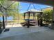 Covered patio with hot tub and gazebo overlooks the lawn and scenic lake at 3169 Connemara Dr, Ormond Beach, FL 32174