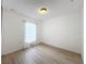 Bright bedroom with light wood floors and window with blinds at 318 Hayman St, Altamonte Springs, FL 32701