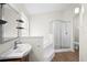Bathroom with soaking tub, shower, and double vanity at 337 Orange Ave, Orange City, FL 32763