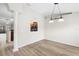 Dining room with kitchen pass-through and wood-look floors at 337 Orange Ave, Orange City, FL 32763