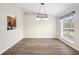 Dining room with kitchen pass-through and wood-look floors at 337 Orange Ave, Orange City, FL 32763