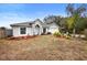 Single story home with gray roof, white exterior, and landscaping at 337 Orange Ave, Orange City, FL 32763