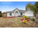 Single story home with gray siding, red mulch, and a two-car garage at 337 Orange Ave, Orange City, FL 32763