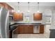 Well-lit kitchen with stainless steel appliances and wood cabinets at 337 Orange Ave, Orange City, FL 32763