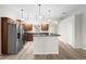Modern kitchen with stainless steel appliances and wood cabinets at 337 Orange Ave, Orange City, FL 32763