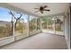 Enjoy this screened porch with a ceiling fan and backyard view at 337 Orange Ave, Orange City, FL 32763