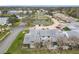 Aerial view of townhouses with tennis court and pond at 347 Castlewood Ln, New Smyrna Beach, FL 32168