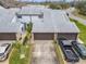 Aerial view of townhouses with grey roofs and brown garage doors at 347 Castlewood Ln, New Smyrna Beach, FL 32168