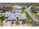 Aerial view of townhouses with tennis courts and pond at 347 Castlewood Ln, New Smyrna Beach, FL 32168