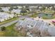 Aerial view of townhouses near tennis courts at 347 Castlewood Ln, New Smyrna Beach, FL 32168