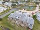Aerial view of townhouses near tennis court and pond at 347 Castlewood Ln, New Smyrna Beach, FL 32168