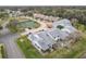 Aerial view of townhouses, tennis court, and pond at 347 Castlewood Ln, New Smyrna Beach, FL 32168