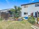 Backyard with patio, screened porch and tropical plants at 347 Castlewood Ln, New Smyrna Beach, FL 32168