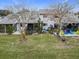 Backyard with patio, screened porch and landscaping at 347 Castlewood Ln, New Smyrna Beach, FL 32168