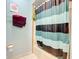 Clean bathroom with tub shower and striped curtain at 347 Castlewood Ln, New Smyrna Beach, FL 32168