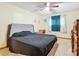 Bedroom with a double bed, window with curtains, and ceiling fan at 347 Castlewood Ln, New Smyrna Beach, FL 32168