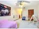 bedroom with a bed, ceiling fan and playful decor at 347 Castlewood Ln, New Smyrna Beach, FL 32168