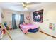 bedroom with pink bed, ceiling fan and educational charts at 347 Castlewood Ln, New Smyrna Beach, FL 32168