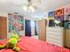 Bedroom with double bed, dresser and large tapestry at 347 Castlewood Ln, New Smyrna Beach, FL 32168