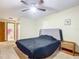 Spacious bedroom with a double bed, nightstand and ceiling fan at 347 Castlewood Ln, New Smyrna Beach, FL 32168