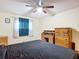 Bedroom with a double bed, dresser, and ceiling fan at 347 Castlewood Ln, New Smyrna Beach, FL 32168