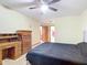 Bright bedroom with a double bed, dresser, and ceiling fan at 347 Castlewood Ln, New Smyrna Beach, FL 32168