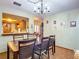 Spacious dining area with kitchen pass-through and chandelier at 347 Castlewood Ln, New Smyrna Beach, FL 32168