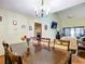 Charming dining room with chandelier and view into kitchen at 347 Castlewood Ln, New Smyrna Beach, FL 32168