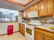 Galley kitchen with oak cabinets and appliances at 347 Castlewood Ln, New Smyrna Beach, FL 32168