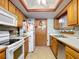 Bright kitchen with oak cabinets and appliances at 347 Castlewood Ln, New Smyrna Beach, FL 32168