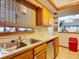 Kitchen with oak cabinets and stainless steel sink at 347 Castlewood Ln, New Smyrna Beach, FL 32168