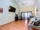 Living room with vaulted ceiling and sliding doors at 347 Castlewood Ln, New Smyrna Beach, FL 32168