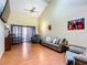 Comfortable living room with sliding glass doors leading to patio at 347 Castlewood Ln, New Smyrna Beach, FL 32168