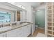 Double vanity bathroom with glass block feature wall at 3737 S Atlantic Ave # 504, Daytona Beach, FL 32118