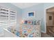 Bright bedroom with white bed frame and colorful bedding at 3737 S Atlantic Ave # 504, Daytona Beach, FL 32118