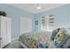 Charming bedroom with light blue walls, and beachy bedding at 3737 S Atlantic Ave # 504, Daytona Beach, FL 32118