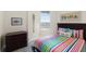 Bedroom with colorful bedding and a dark wood frame at 3737 S Atlantic Ave # 504, Daytona Beach, FL 32118